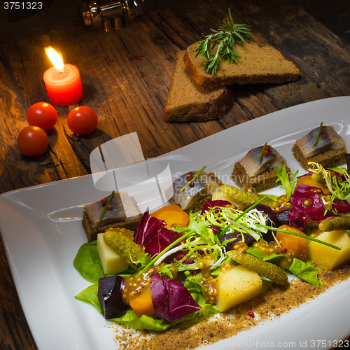 Image of Canape from rye bread with herring slice 