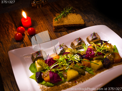 Image of Canape from rye bread with herring slice 