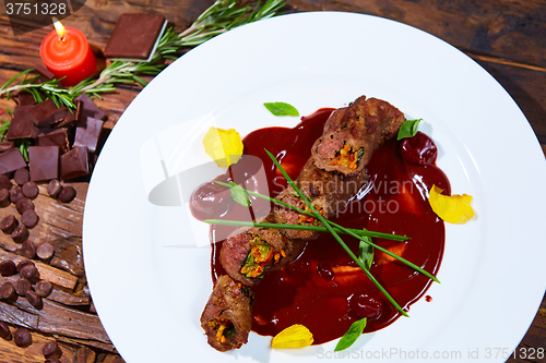 Image of Roasted meat with vegetables and chocolate sauce