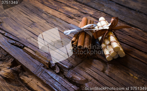 Image of Cinnamon sticks on wooden background