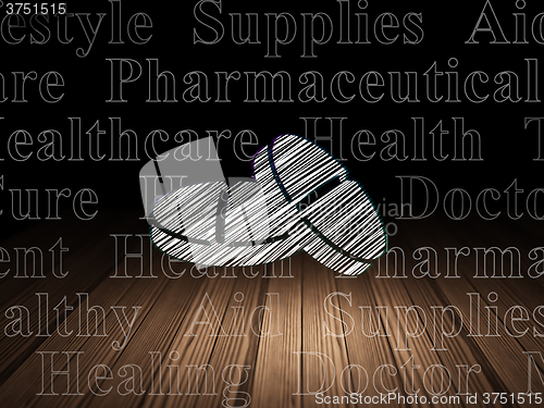 Image of Health concept: Pills in grunge dark room