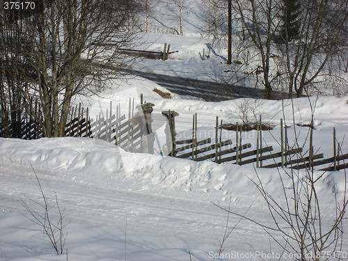 Image of Old wooden fence in the snow