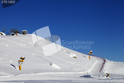 Image of Ski slope with snowmaking at sun day