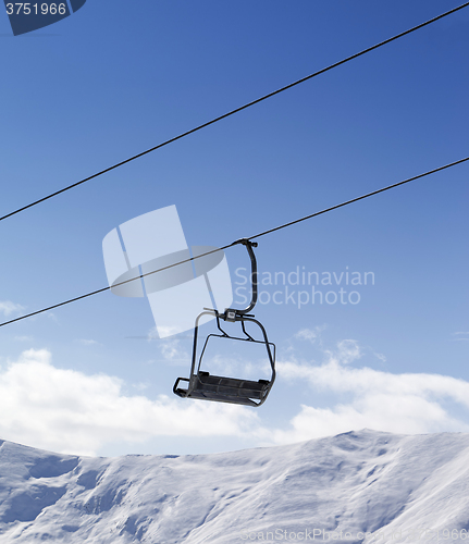 Image of Chair lift against blue sky