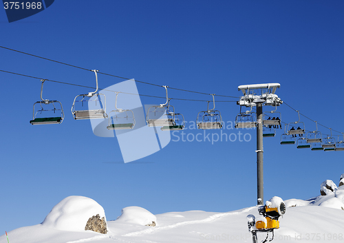 Image of Chair-lift at ski resort at sun day after snowfall