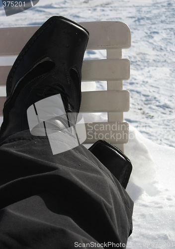 Image of Resting the legs on a chair in the snow