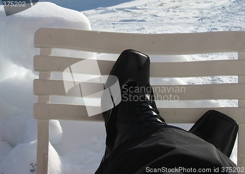 Image of Crossed feet on a chair