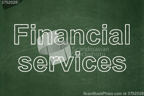 Image of Money concept: Financial Services on chalkboard background