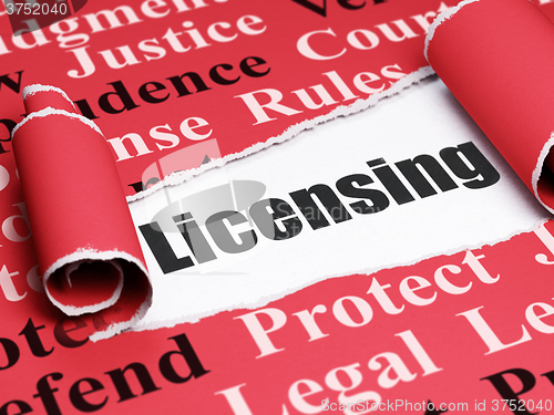 Image of Law concept: black text Licensing under the piece of  torn paper