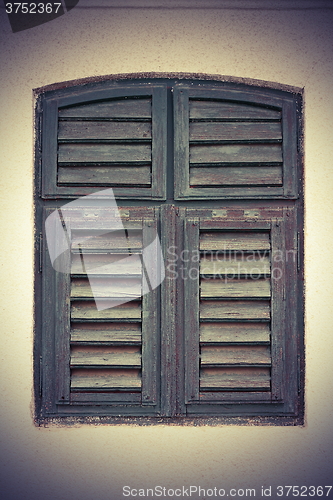 Image of green painted blinds on window