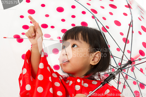 Image of Chinese Little Girl Holding umbrella with raincoat