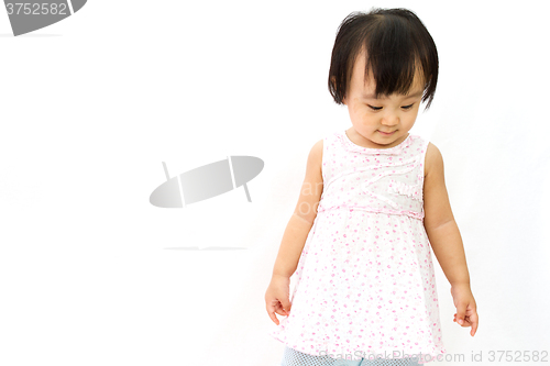 Image of Chinese Little Girl Looks down for a portrait in studio