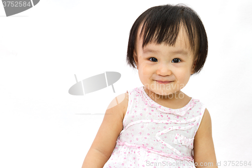 Image of Chinese Little Girl Smiles for a portrait in studio