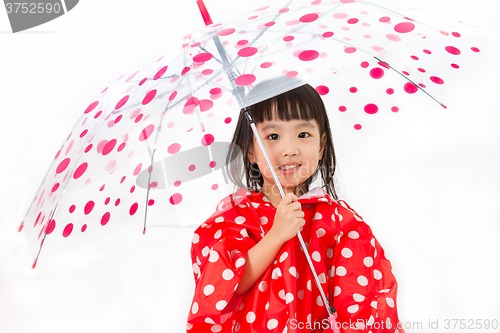 Image of Chinese Little Girl Holding umbrella with raincoat