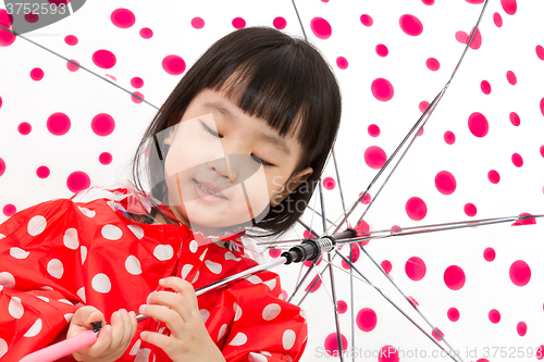 Image of Chinese Little Girl Holding umbrella with raincoat