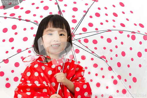 Image of Chinese Little Girl Holding umbrella with raincoat