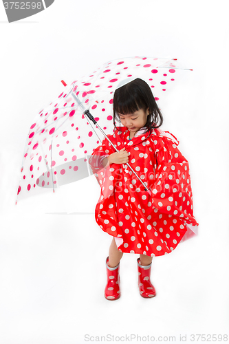 Image of Chinese Little Girl Holding umbrella with raincoat