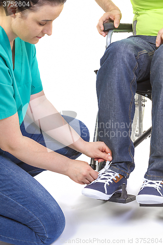 Image of Nurse helping a disabled young man in wheelchair
