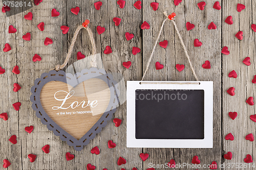 Image of Empty wooden blackboard sign and heart shape frame