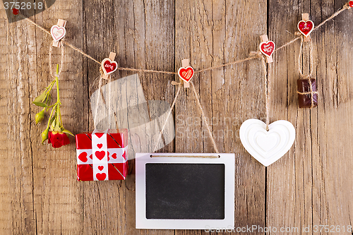 Image of Red rose with gift box and white shape heart and chocolate