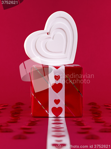 Image of white shape heart over gift box