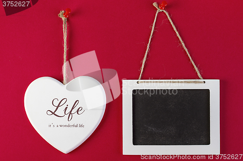 Image of Love heart and emty blackboard on red