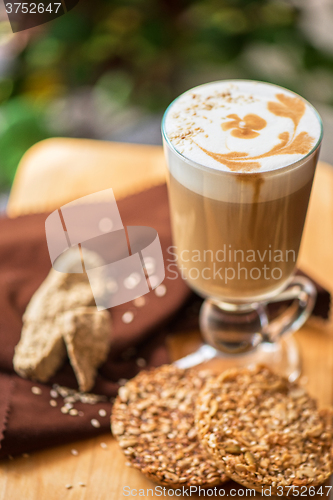 Image of coffee latte cup with cookies