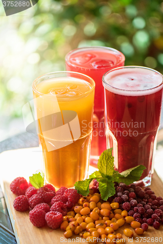 Image of fruit drink with cranberries raspberries and sea buckthorn