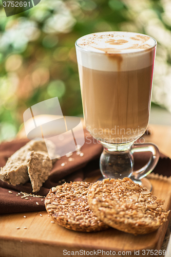 Image of coffee latte cup with cookies