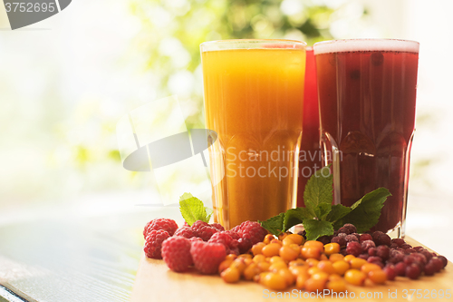 Image of fruit drink with cranberries raspberries and sea buckthorn