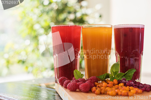 Image of fruit drink with cranberries raspberries and sea buckthorn