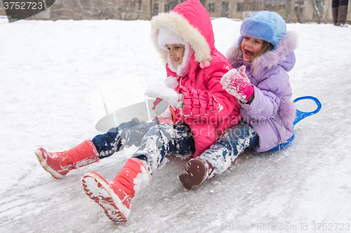 Image of Two girls rolling ice slides