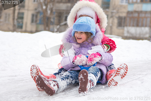 Image of Two girls rolling ice slides