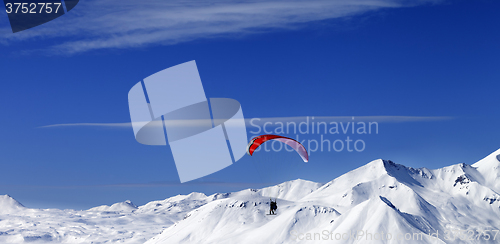 Image of Panoramic view on sky gliding in snowy mountains at nice sun day