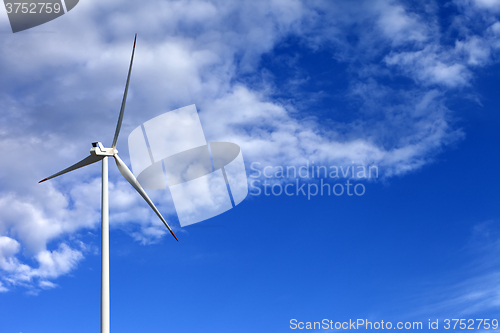 Image of Wind turbine and blue sunlight sky