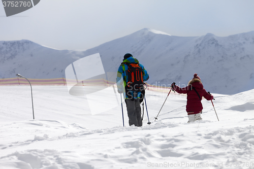 Image of Father and daughter on ski resort after snowfall