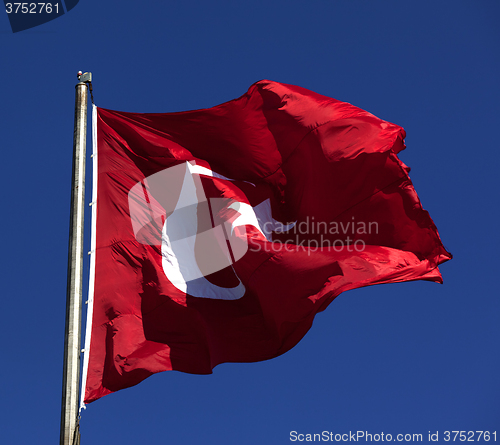 Image of Sunlight Turkish flag waving in wind at sunny day