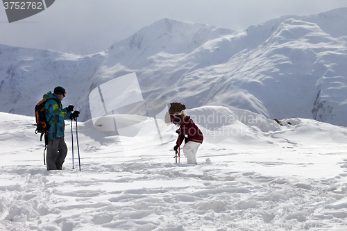 Image of Father and daughter on ski resort after snowfall.