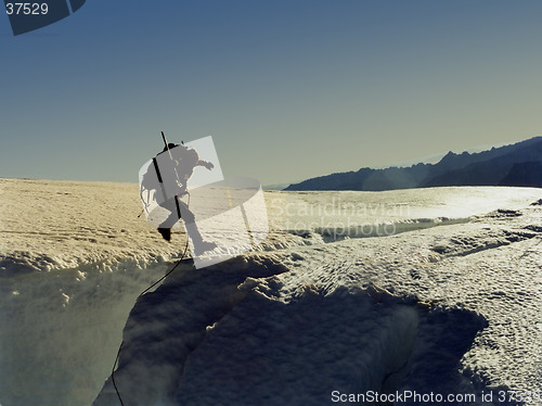 Image of Climber jumping a crevasse