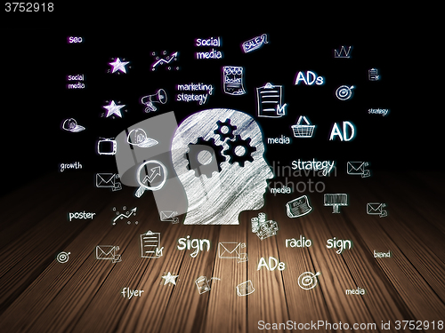 Image of Advertising concept: Head With Gears in grunge dark room