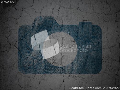 Image of Vacation concept: Photo Camera on grunge wall background
