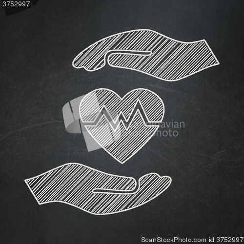 Image of Insurance concept: Heart And Palm on chalkboard background