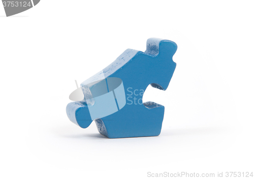 Image of Closeup of big blue jigsaw puzzle piece