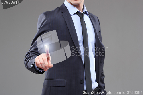 Image of business, technology, internet and networking concept - businessman pressing button with contact on virtual screens. 