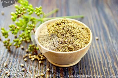 Image of Coriander powder in bowl on board