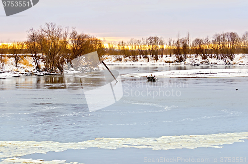 Image of River with ice and snow-covered beach with trees