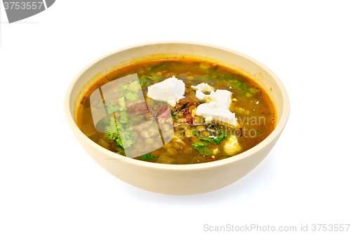 Image of Soup lentil with spinach and cheese in yellow bowl