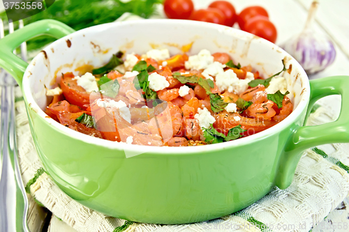 Image of Shrimp and tomatoes with feta in pan on napkin