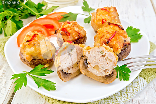 Image of Champignons stuffed meat cut in white plate on light board