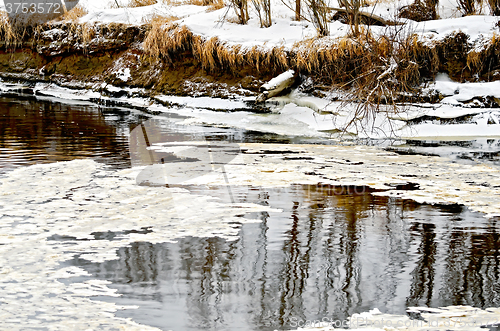 Image of Ice in water and snow on the shore